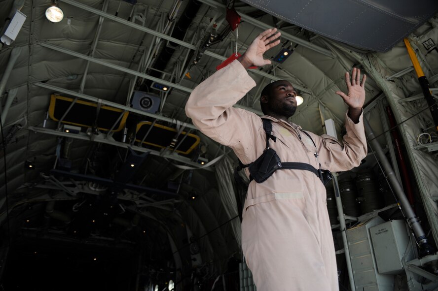 Staff Sgt. Brian Commodore, a loadmaster assigned to the 772nd Expeditionary Airlift Squadron, directs the movement of pallets into the cargo bay of a C-130J Super Hercules, in preparation for a night airdrop to deliver JP-8 fuel to troops on the ground in southwestern Afghanistan July 17, 2009. Sergeant Commodore is deployed from the 41st Airlift Squadron, Little Rock Air Force Base, Ark. (U.S. Air Force Photo/Staff Sgt. Shawn Weismiller)