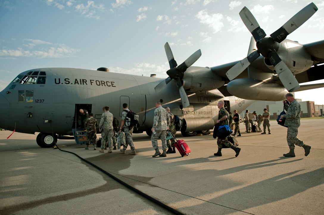 Members of the 123rd Airlift Wing board a C-130 at the Kentucky Air National Guard Base in Louisville, Ky., on Aug. 17. The troops are among 72 Kentucky Air Guardsmen who are deploying to Ramstein Air Base, Germany, through Sept. 5 to support Operation Joint Enterprise. The airlift mission supports U.S. military operations across Europe and Africa. (U.S. Air Force photo by Maj. Dale Greer.)