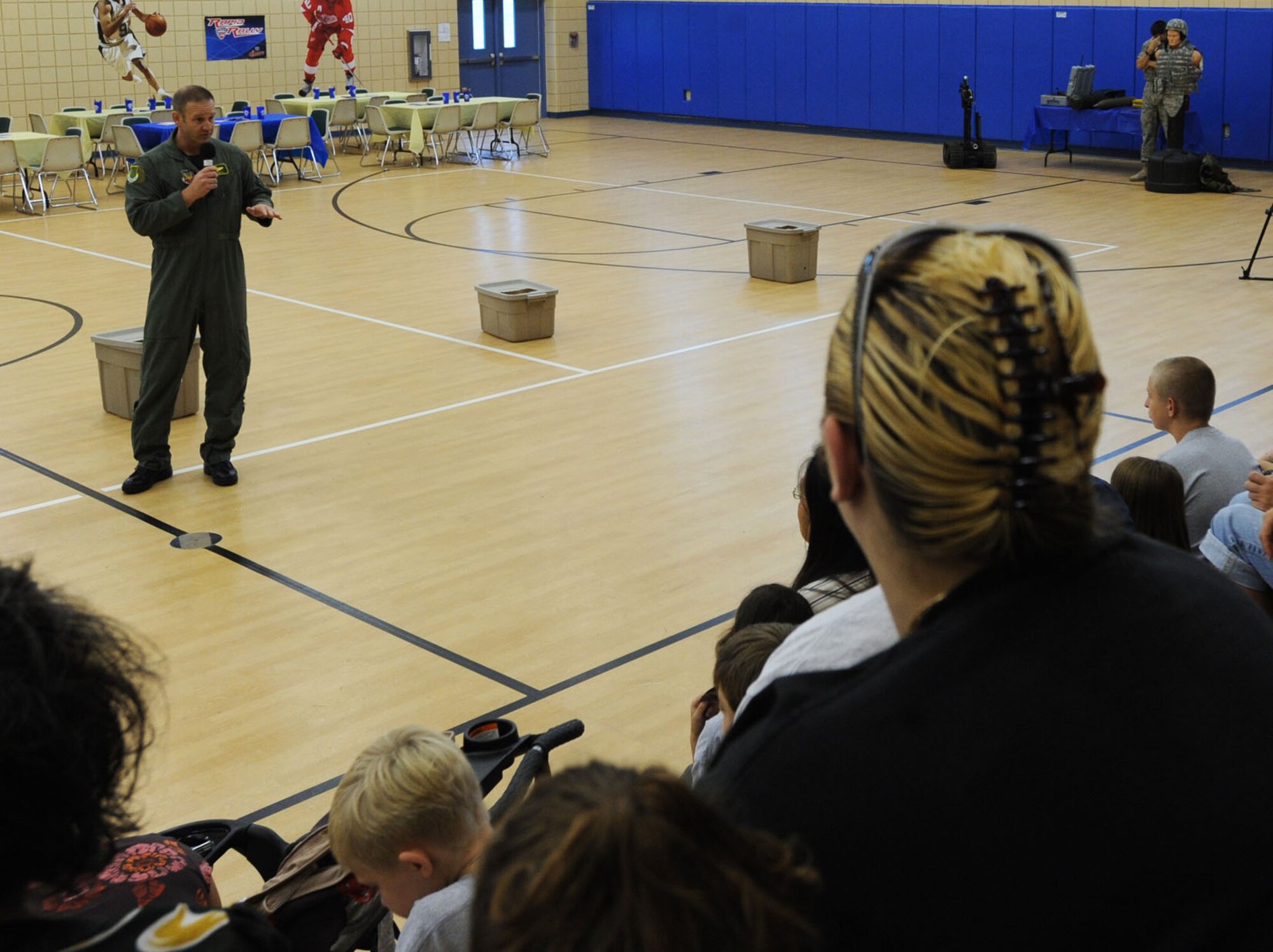 LANGLEY AIR FORCE BASE, Va. -- Col. Dirk Smith, 1st Operations Group commander, speaks to children attending the Operation Hero here Aug. 14.  Operation Hero shows children some of the ways their parents prepare for deployment by letting them participate in various hands on activities. (U.S. Air Force photo/Senior Airman Scott Aldridge)