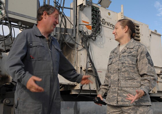 SPANGDAHLEM AIR BASE, Germany – Chief Master Sgt. Stacey Tuckwell, 52nd Operations Support Squadron airfield manager, speaks with a contractor for the 86th Construction Training Squadron about the progress of the concrete replacement project Aug. 13. Chief Tuckwell was recently recognized by the American Association of Airport Executives for being awarded the 2008 U.S. Air Force Airfield Manager of the Year Award. (U.S. Air Force photo/Senior Airman Benjamin Wilson)
