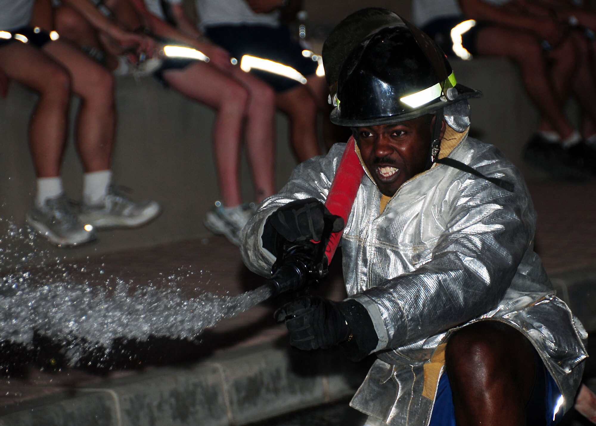 SOUTHWEST ASIA -- Chief Master Sgt. Marcus Snoddy, 386th Expeditionary Mission Support Group superintendent, aims a charged hose line at targets during a fire fighter challenge held at an undisclosed location in Southwest Asia Aug. 16, 2009.  The fire fighter challenge was made up of five events including: the Hurst tool run, high rise pack run, forcible entry trainer, dummy drag and a charged hose line run to knock over objects.  Chief Snoddy is deployed from the 425th Air Base Squadron, Izmir, Turkey and hails from Birmingham, Ala.  (U.S. Air Force photo / Tech Sgt. Tony Tolley / Released)