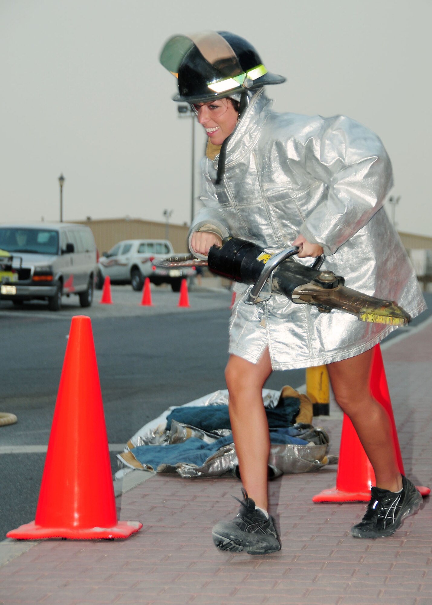 SOUTHWEST ASIA -- Senior Airman Leah Sands, 386th Expeditionary Logistics Readiness Squadron shipment planner, runs with a Hurst tool during a fire fighter challenge held at an undisclosed location in Southwest Asia August 16.  The fire fighter challenge was made up of five events including: the Hurst tool run, high rise pack run, forcible entry trainer, dummy drag and a charged hose line run to knock over objects.  Airman Sands is deployed from the 122nd Fighter Wing, Ft. Wayne, Ind. and hails from Ossian, Ind.  (U.S. Air Force photo/Tech Sgt. Tony Tolley)