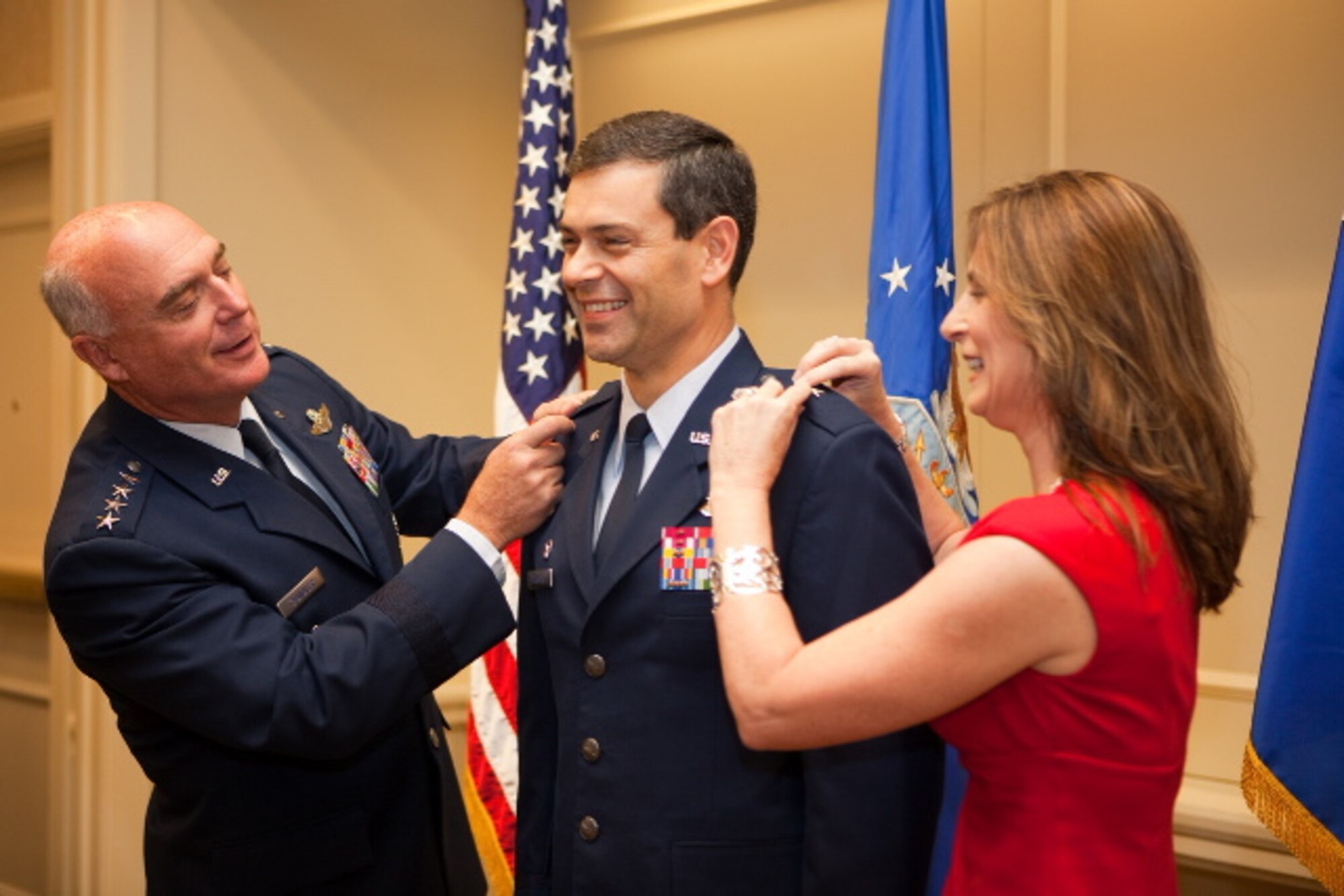 General Carroll "Howie" Chandler and Cindy Wilsbach each pin a star onto the epaulets of Brig. Gen. Kenneth Wilsbach, 18th Wing commander, during a ceremony in Washington D.C. (U.S. Air Force photo / Matt Harmon)