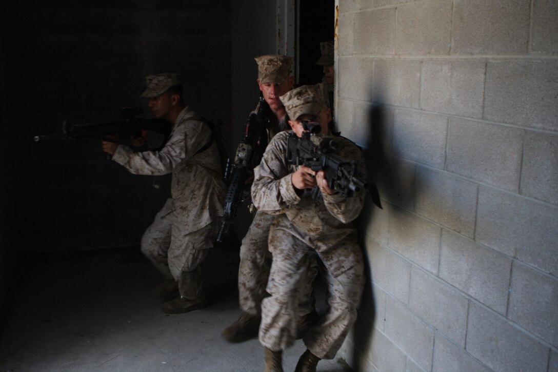 Lance Cpl. David D. Burt Jr., rifleman, 2nd platoon, Charlie Company, Battalion Landing Team 1st Battalion, 9th Marine Regiment, 24th Marine Expeditionary Unit, leads his team down a hallway as they conduct room-clearing exercises at the Military Operations in Urban Terrain facility at Camp Lejeune, N.C. Aug. 17, during the Heliborne Company Raid Course.  Charlie Company trained with Special Operations Training Group to become the 24th MEU’s helo raid force for its upcoming deployment.  (U.S. Marine Corps photo by Cpl. Alex C. Guerra)