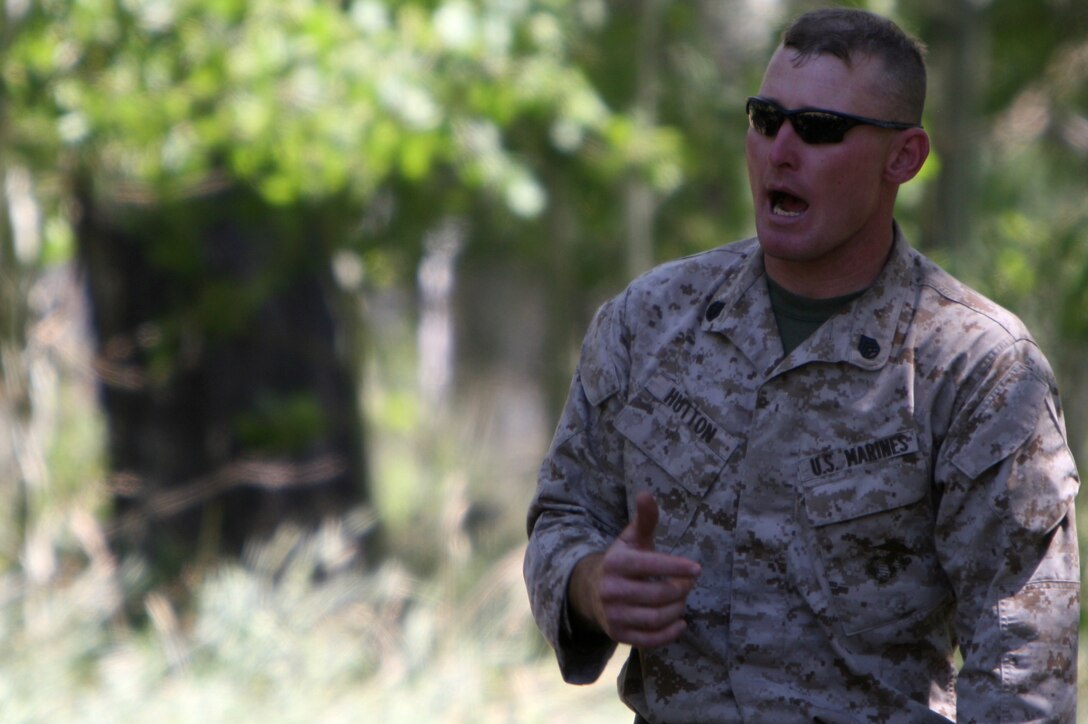 Staff Sgt. Michael P. Hutton, a mountain warfare instructor with the Unit Training Group, gives a signaling class to Marines and sailors of 3rd Battalion, 7th Marine Regiment, based out of Marine Corps Air Ground Combat Center Twentynine Palms, Calif., during the battalion’s pre-environmental training here Aug. 18. Hutton and other UTG instructors can spend up to three weeks in the field at a time while training units.