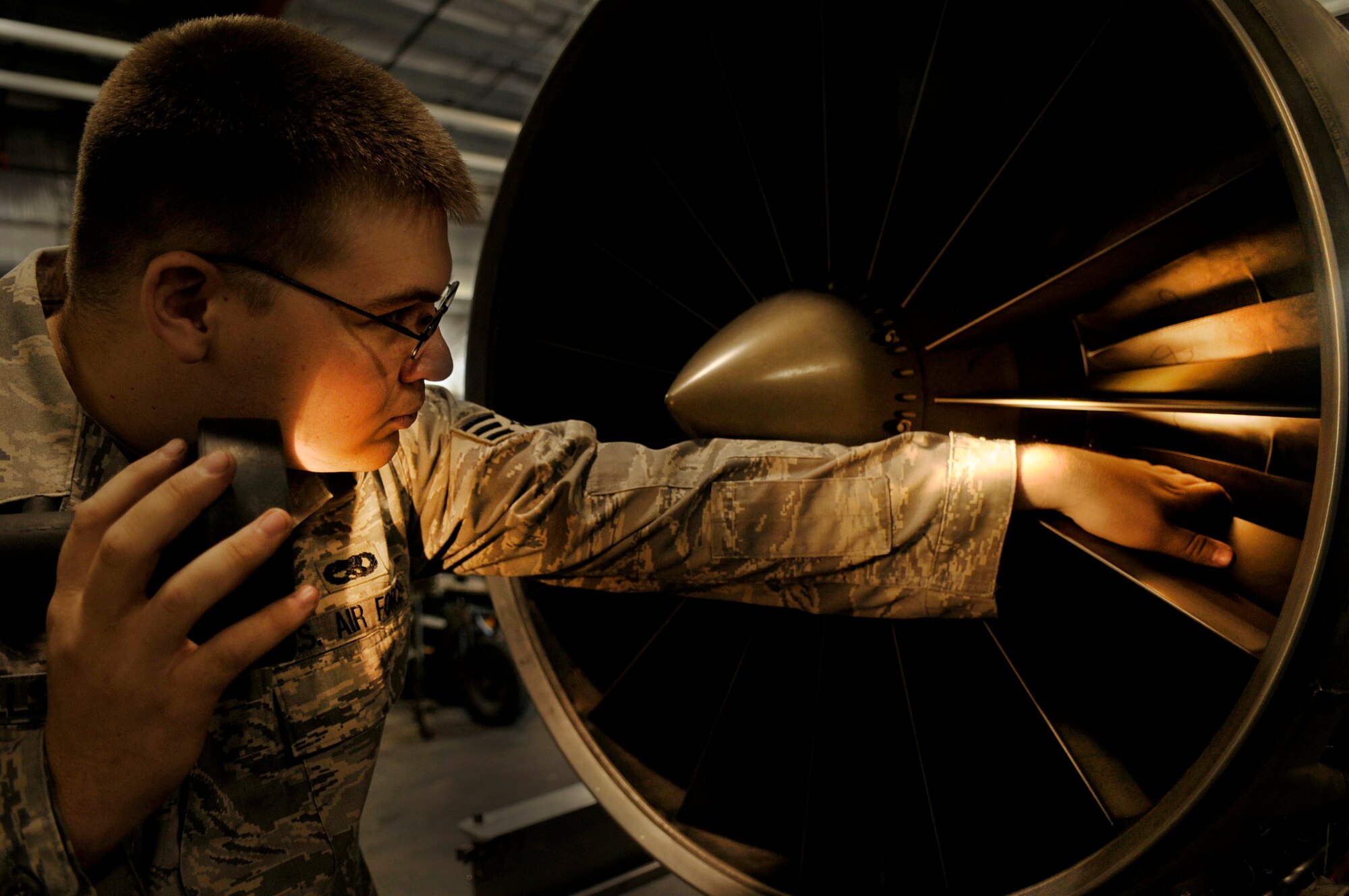 Senior Airman William Hills performs an inlet inspection Aug. 12, 2009, Eielson Air Force Base, Alaska. The check is performed during a routine maintenance assessment to look for knicks or foreign object damage to the blades. Airman Hill is an Air Space Propulsions Jet mechanic assigned to the 354th Maintenance Squadron. (U.S. Air Force photo/Airman 1st Class Laura Goodgame)