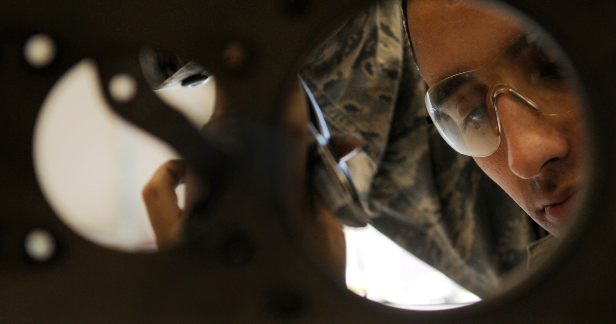 Airman 1st Class Joseph Bell removes a safety wire from a fuel tube of a lower duct of a General Electric F110 engine Aug. 12, 2009, Eielson Air Force Base, Alaska. The F110 is an afterburning turbofan jet engine. Airman Bell is an Air Space Propulsions Jet Mechanic assigned to the 354th Maintenance Squadron. (U.S. Air Force photo/Airman 1st Class Laura Goodgame)