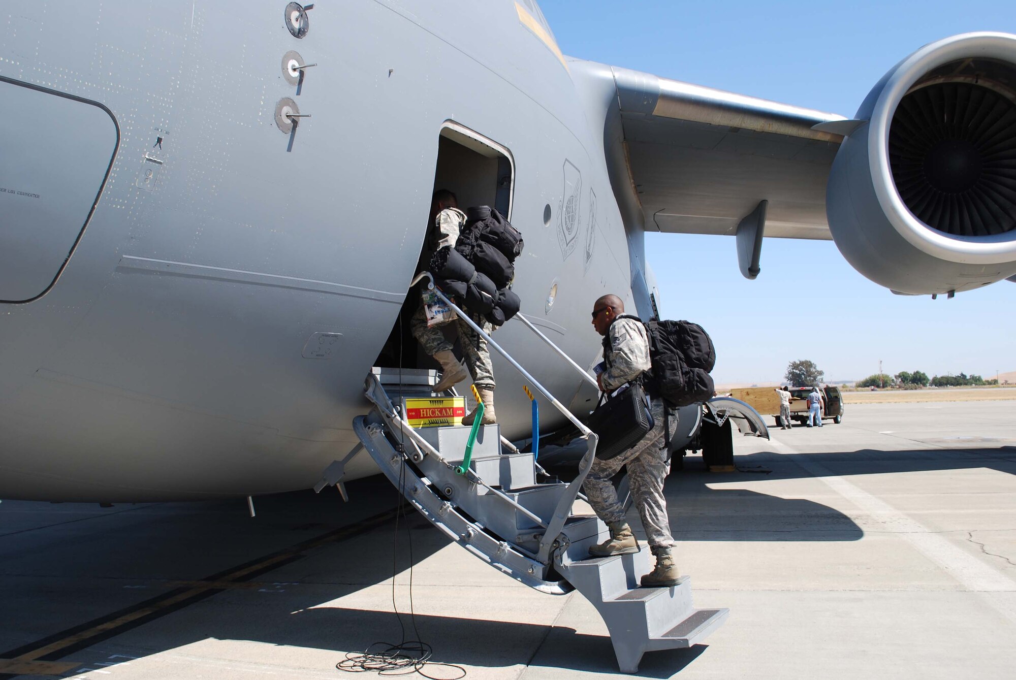 Members of the 615th Contingency Response Wing board a C-17 at Travis AFB for their deployment in support of Operation Enduring Freedom.  
