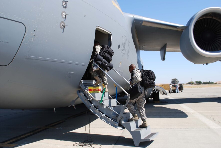 Members of the 615th Contingency Response Wing board a C-17 Globemaster III at Travis Air Force Base, Calif., for their deployment in support of Operation Enduring Freedom.