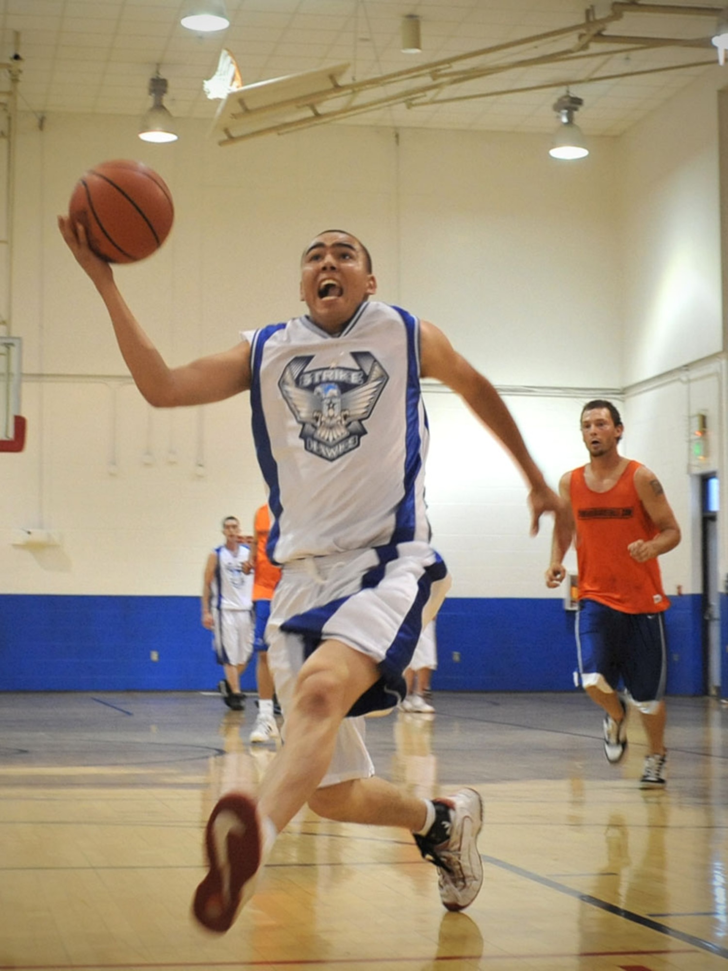 SPOKANE, Wash.–Airman 1st Class Marcus Bertelsen, 92nd Logistics Readiness Squadron, drives the ball to the basket timeout at the East Central Community Center July 31. The Fairchild Varsity Basketball Team had a perfect-record season after a 10-game streak. (U.S. Air Force photo / Staff Sgt JT May III)