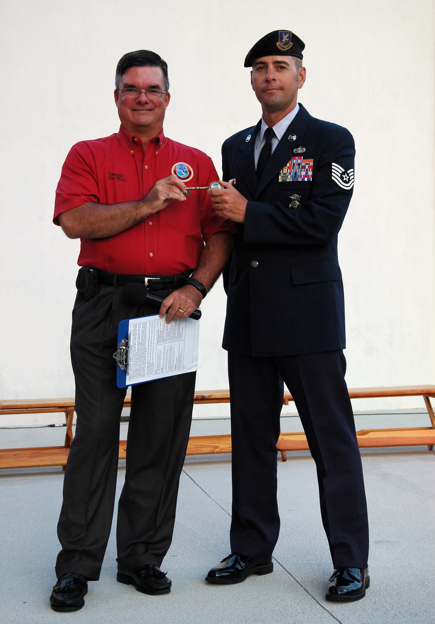 Tech. Sgt. Andy Shomake, non-commissioned officer in charge of the 96th Ground Combat Training Squadron's Military Working Dog Track, accepts a key to the city of Destin from city councilman, Jim Wood, during the Red, White and Blue Celebration Aug 13. The Pascagoula, Miss., native was the last Eglin servicemember to be recognized during the summer celebration. (U.S. Air Force Photo/Jasmine DeNamur)