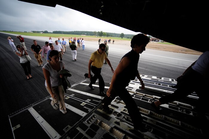 Civilians from the Charleston area board a C-17 at North Field after watching aircrews perform an airdrop Aug. 13. (Air Force photo/Staff Sgt. Jacob Bailey)