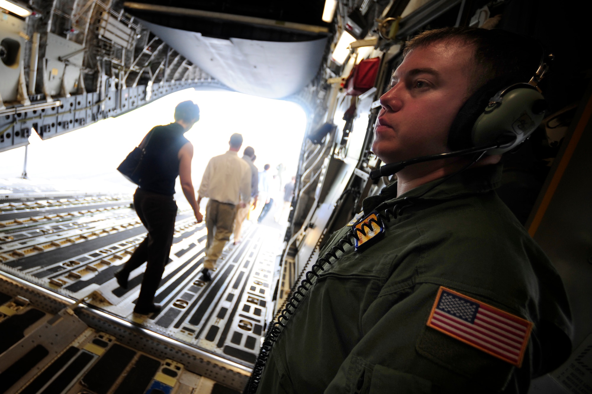 Tech. Sgt. Keith Bryer watches closely as civilians from the Charleston area safely exit a C-17 after a civic leader orientation flight here Aug. 13. Sergeant Bryer is a loadmaster with the 16th Airlift Squadron. (Air Force photo/Staff Sgt. Jacob Bailey)