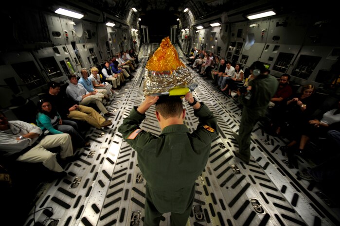 Senior Airman Kevin Blumschumacher performs a pre-flight safety brief for civilians from the Charleston area on how to properly don an Emergency Passenger Oxygen System before a civic leader orientation flight here Aug. 13. Airman Blumschumacher is a loadmaster with the 17th Airlift Squadron. (Air Force photo/Staff Sgt. Jacob Bailey)