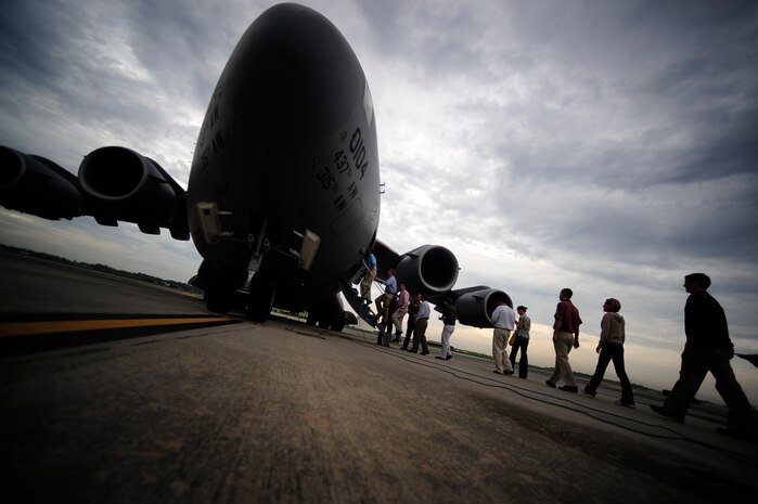 Civilians from the Charleston area board a C-17 aircraft before a civic leader orientation flight on the flightline here Aug. 13. The orientation flight offers leadership from the local area an intensive and up-close look at the way Charleston Airmen accomplish the mission. (Air Force photo/Staff Sgt. Jacob Bailey)