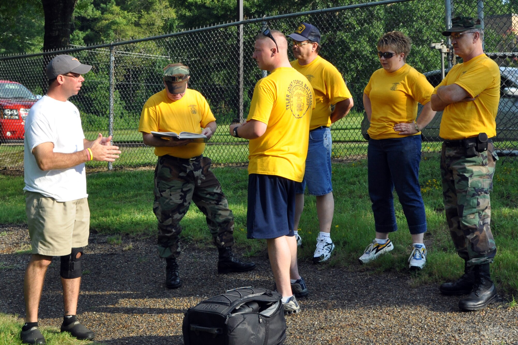 James Whitaker, activities therapy coordinator, East Texas Medical Center/Behavioral Health Center briefs officers from the TYLER JOINT FORCE Battalion of the U.S. Naval Sea Cadets Corps about safety precautions for the cadets before commencing a day of exercises at the Behavioral Health Center in Tyler, Texas, August 15, 2009. The exercises are designed to enhance team work and trust between the cadets. They also teach participants planning techniques, how to be aware of their surroundings and the benefits of a support system. The cadets spent the entire day completing exercises which will enable them to work closer with and trust their fellow cadets in the future. These experiences will greatly benefit those cadets who decide to join the U.S. Military in the future. (L to R) James Whitaker, Ensign Dean Bailey, supply officer, Ensign Kyle Stowers, operations officer, Ensign Bill Fiser, executive officer, Lt. j.g. Connie Fiser, commanding officer and Lt. Jeff Walston, public affairs officer. (Courtesy photo) 