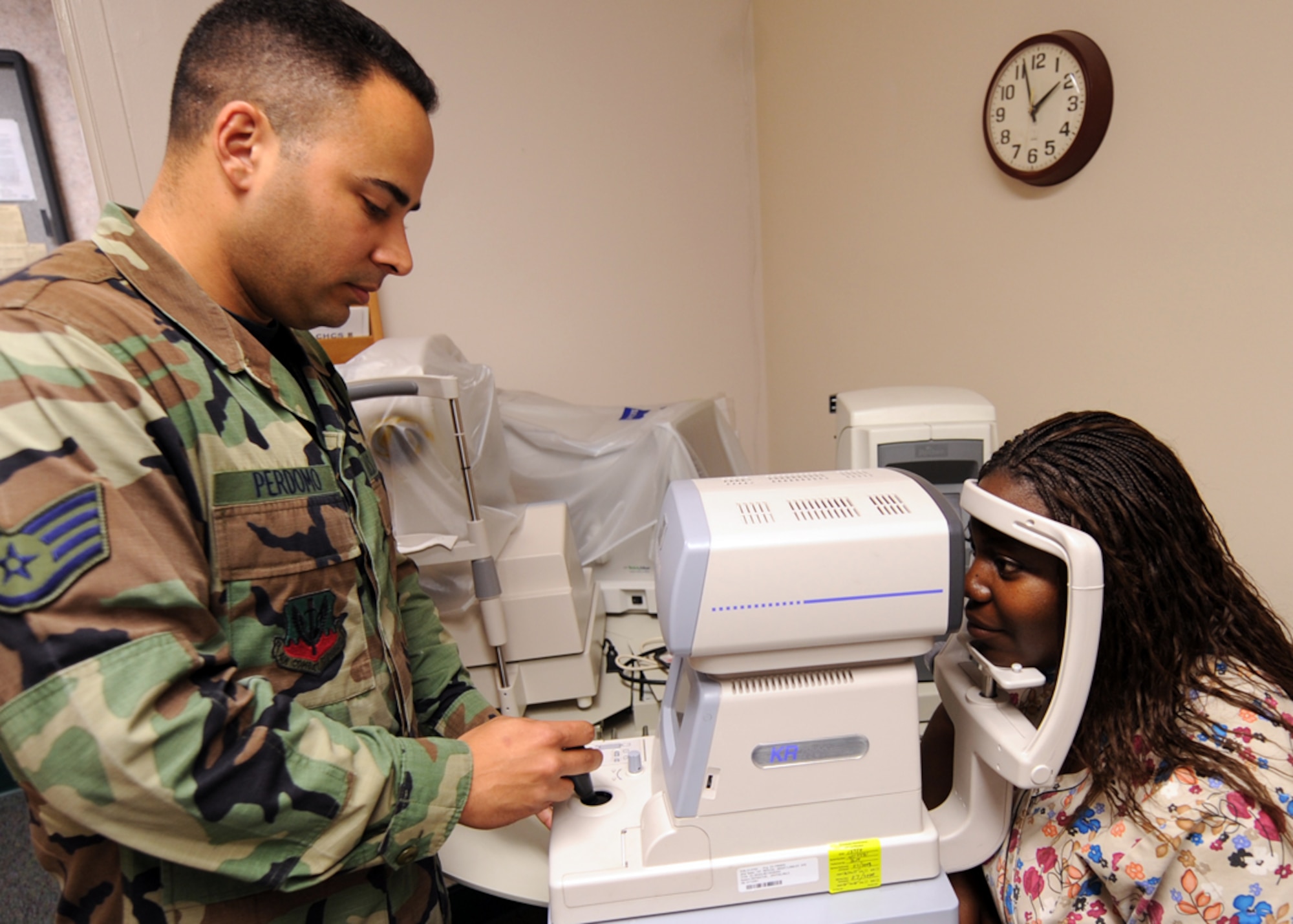 LANGLEY AIR FORCE BASE, Va. -- Tech. Sgt. Bryce Perdomo, 1st Aerospace Medicine Squadron ophthalmic craftsman, administers an Auto Kerato-Refraction test to Tiffany Alston, certified ophthalmic assistant here Aug. 18.  August is National Children's Vision and Learning Month, so before children start heading back to the classroom, the American Optometric Association (AOA) recommends a visit to the optometrist.  (U.S. Air Force photo/Airman 1st Class Jonathan Koob) 