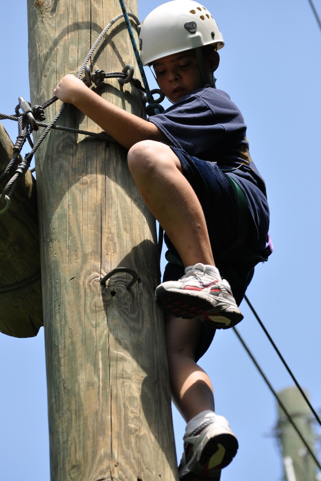 Navy League Cadet Corps Recruit Chase McDow ascends more than 20 feet up a pole in order to complete an exercise at the East Texas Medical Center/Behavioral Health Center in Tyler, Texas, August 15, 2009. Only 11 years old, Recruit McDow, overcame a severe fear of heights with the support of his fellow cadets to accomplish his mission. He is a member of the TYLER JOINT FORCE Battalion of the U.S. Naval Sea Cadets Corps based in Tyler. This was Recruit McDow second weekend drill with the unit and he spent the entire day completing exercises which will enable him to build trust in his fellow cadets. Recruit McDow is from Jacksonville, Texas. The NLCC is for boys and girls, at least 11 but not yet 14 years old who are interested in the sea and ships, and the nation’s seagoing services. The Navy League program is designed to introduce young people to maritime and military life, and to prepare them for later entrance into the Naval Sea cadet Corps. (Courtesy photo)     