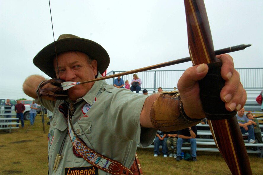 MINOT AIR FORCE BASE, N.D. -- The world’s greatest expedition shooter, Byron Ferguson of Hartselle, Alabama, showcases his skills with an archery demonstration during the grand opening of the new 3-D archery range here, Aug. 15. Ferguson came to Minot to open the 3-D archery range hosted by outdoor recreation, talk about archery safety, and to demonstrate some of his trick shots with his long bow. (U.S.  Air Force photo by Airman 1st Class Jesse Lopez)