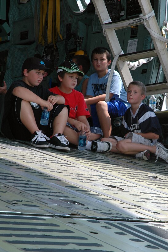 YOUNGSTOWN AIR RESERVE STATION, Ohio -- Young air show visitors rest on the ramp of a visiting C-17 Globemaster III aircraft on the YARS flightline Aug. 9, 2009, while they await an aerial demonstration by the U.S. Air Force Thunderbirds Air Demonstration Squadron.  The children, along with more than 65,000 visitors, watch numerous flying acts during the 2-day air show. U.S. Air Force photo by Senior Airman Brenda Haines   