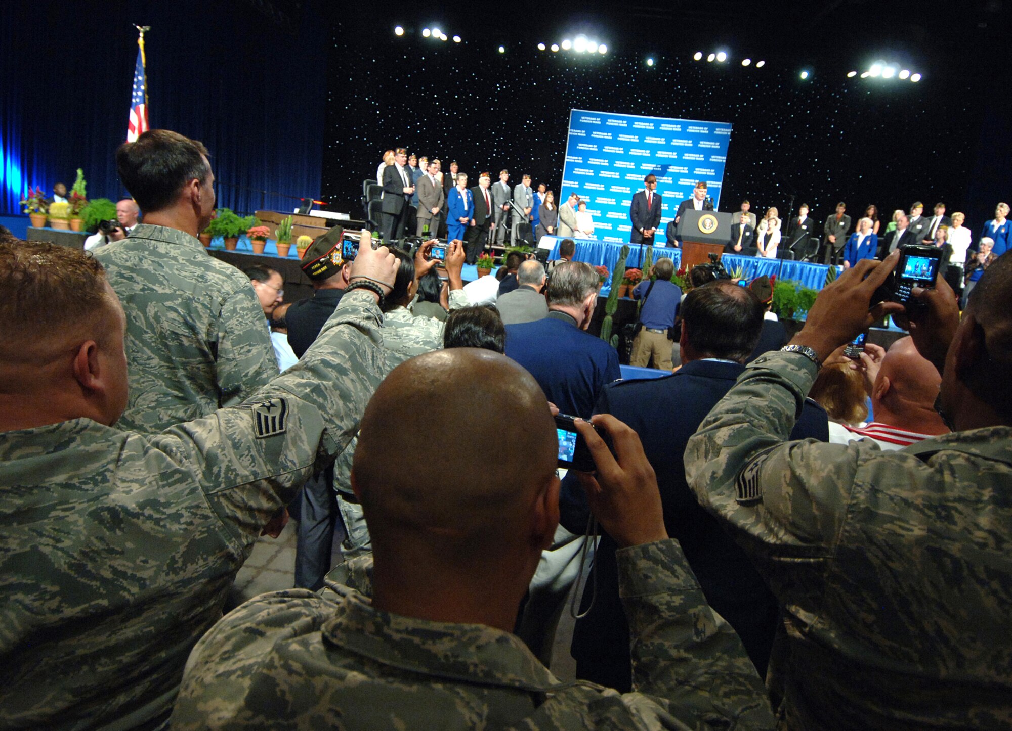 Airmen from Luke AFB, Ariz., hold up personal cameras in an attempt to photograph President Barak Obama at the 110th VFW National Convention at the Phoenix Convention Center.  (U.S. Air Force photo by Tech. Sgt. Jeffrey A. Wolfe)