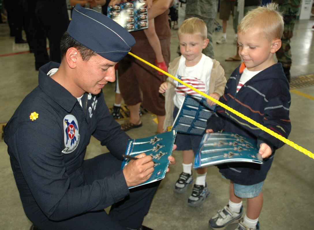 YOUNGSTOWN AIR RESERVE STATION, Ohio -- Maj. John Baum,  a pilot with the U.S. Air Force Thunderbirds Demonstration Squadron, signs autographs for children following the Thunderbirds' "Thunder Over the Valley" Air Show and Open House performance, Aug. 8, 2009. The YARS Air Show attracted more than 65,000 visitors to the air station for the free, 2-day event. U.S. Air Force photo by Airman 1st Class Megan Tomkins