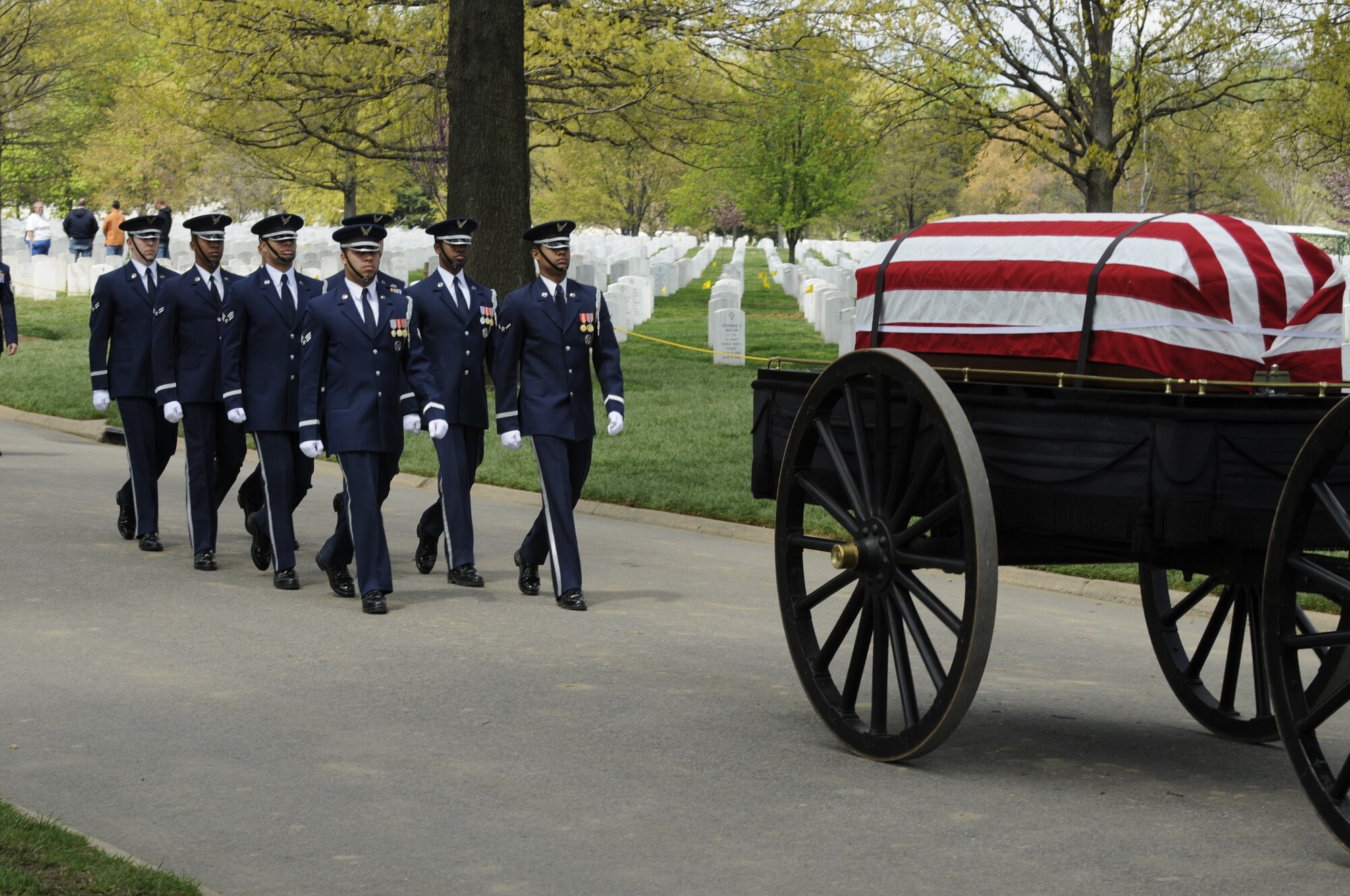 A United States Air Force Honor Guard body bearer team marches behind a caisson during a full honors funeral ceremony at Arlington National Cemetery. Honor guard body bearers train constantly to maintain the precision they are known for. Their standards of flawlessness are set out of necessity to honor fallen Airmen. (U.S. Air Force photo by Staff Sgt. Daniel DeCook)