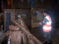 SEYMOUR JOHNSON AIR FORCE BASE, N.C. -- Senior Airman Nallelis Madrigal of travel management performs a "re-pack" for a military member's move.
 She thoroughly takes inventory of all of the household goods and watches the military service carrier pack and take inventory of the shipment. Airman Madrigal is a Reservist with the 916th Logistics Readiness Squadron and spent her annual tour in England. (U.S. Air Force photo by: SSgt. Monica Leonvelez, 916 LRS)
