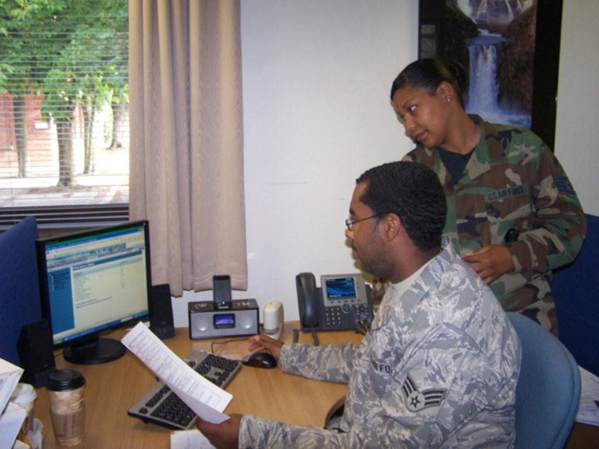 SEYMOUR JOHNSON AIR FORCE BASE, N.C. -- Staff Sgt Sarita Jordan of travel management trains on the Defense Personal Property System (DPS) with Senior Airman Evans from the 100th Logistics Readiness Squadron stationed at Mildenhall. Sergeant Jordan was there performing annual tour with the 916th Logistics Readiness Squadron. (U.S. Air Force photo by: SSgt. Monica Leonvelez, 916 LRS)