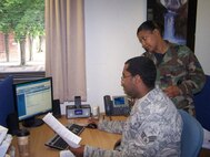 SEYMOUR JOHNSON AIR FORCE BASE, N.C. -- Staff Sgt Sarita Jordan of travel management trains on the Defense Personal Property System (DPS) with Senior Airman Evans from the 100th Logistics Readiness Squadron stationed at Mildenhall. Sergeant Jordan was there performing annual tour with the 916th Logistics Readiness Squadron. (U.S. Air Force photo by: SSgt. Monica Leonvelez, 916 LRS)