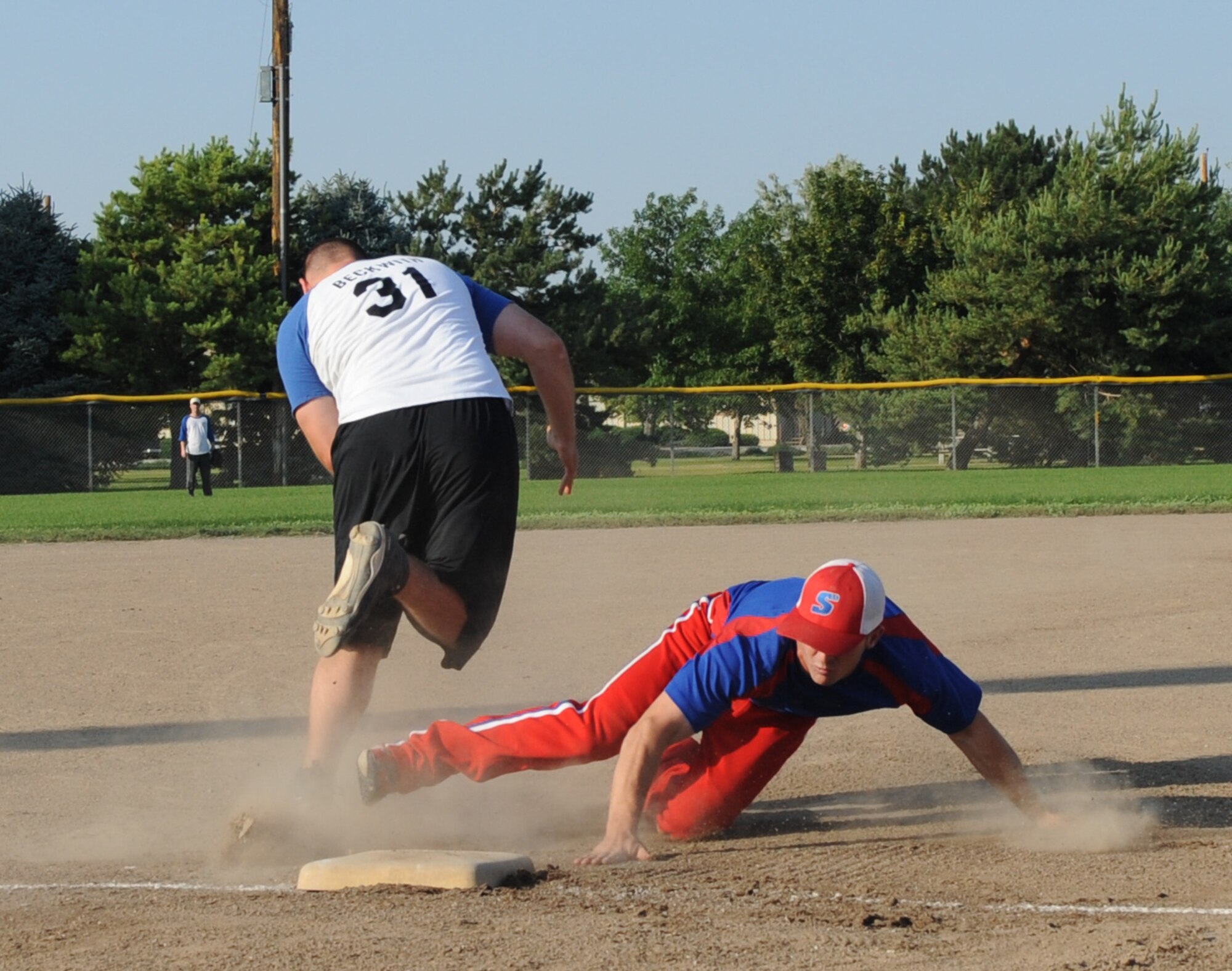 MOUNTAIN HOME AIR FORCE BASE, Idaho -- Jeremy Cummins, 366th Logistic Readiness Squadron second baseman, slides into third base during the championship games against the 366th Operation Support Squadron Aug. 10. LRS defeated OSS 7-2 for the intramural softball title. (U.S. Air Force photo by Airman 1st Class Renishia Richardson)