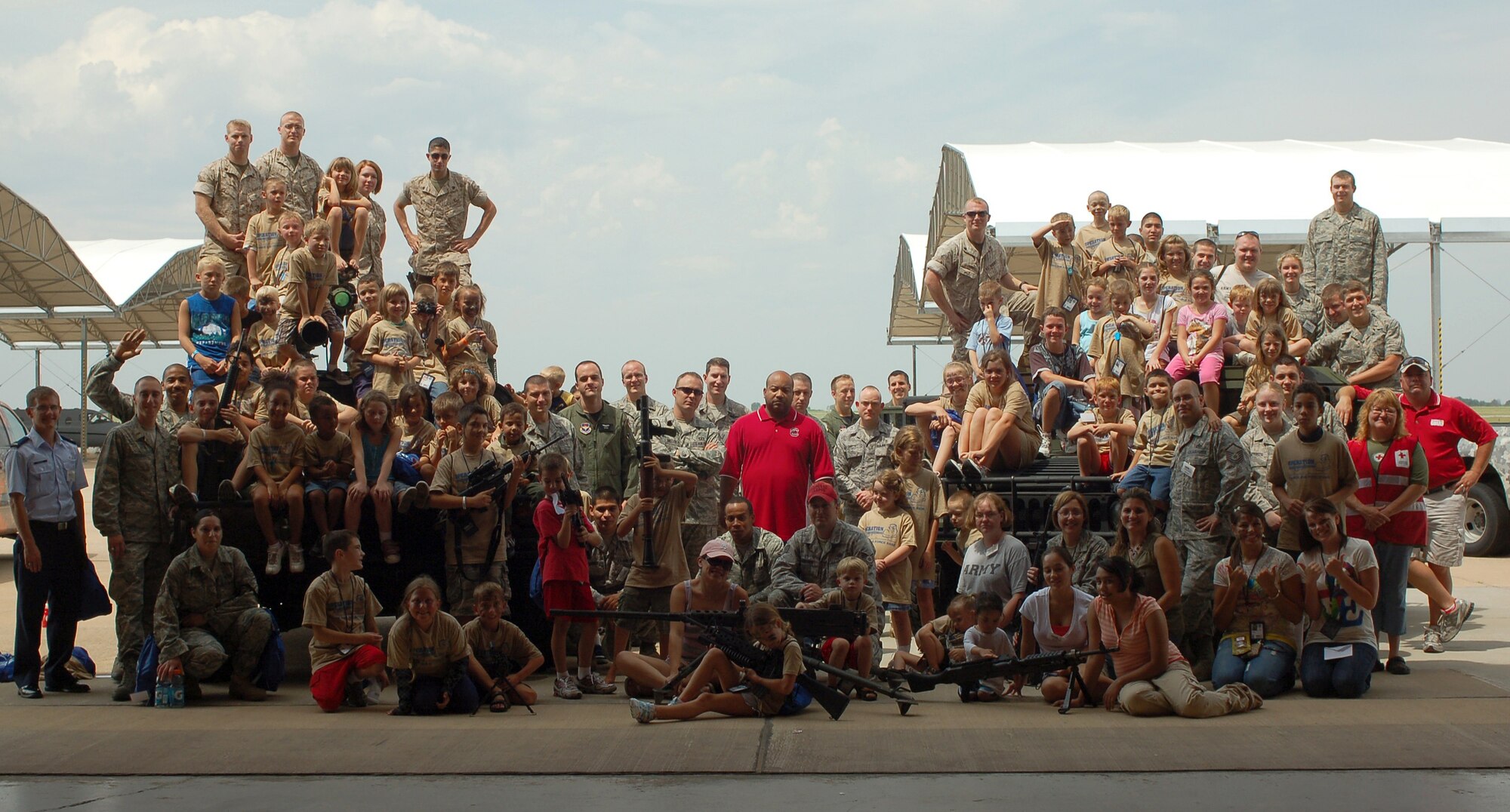 The volunteers who helped with the Operation KIDS event pose with the young participants at Camp Liberty in Hangar 170, the “deployment” site for the event, Aug. 6 at Vance AFB, Okla.  Operation KIDS was a hands-on activity for children of military families to learn about their parents’ deployment process. (U.S. Air Force photo/ Lisa Hoth)