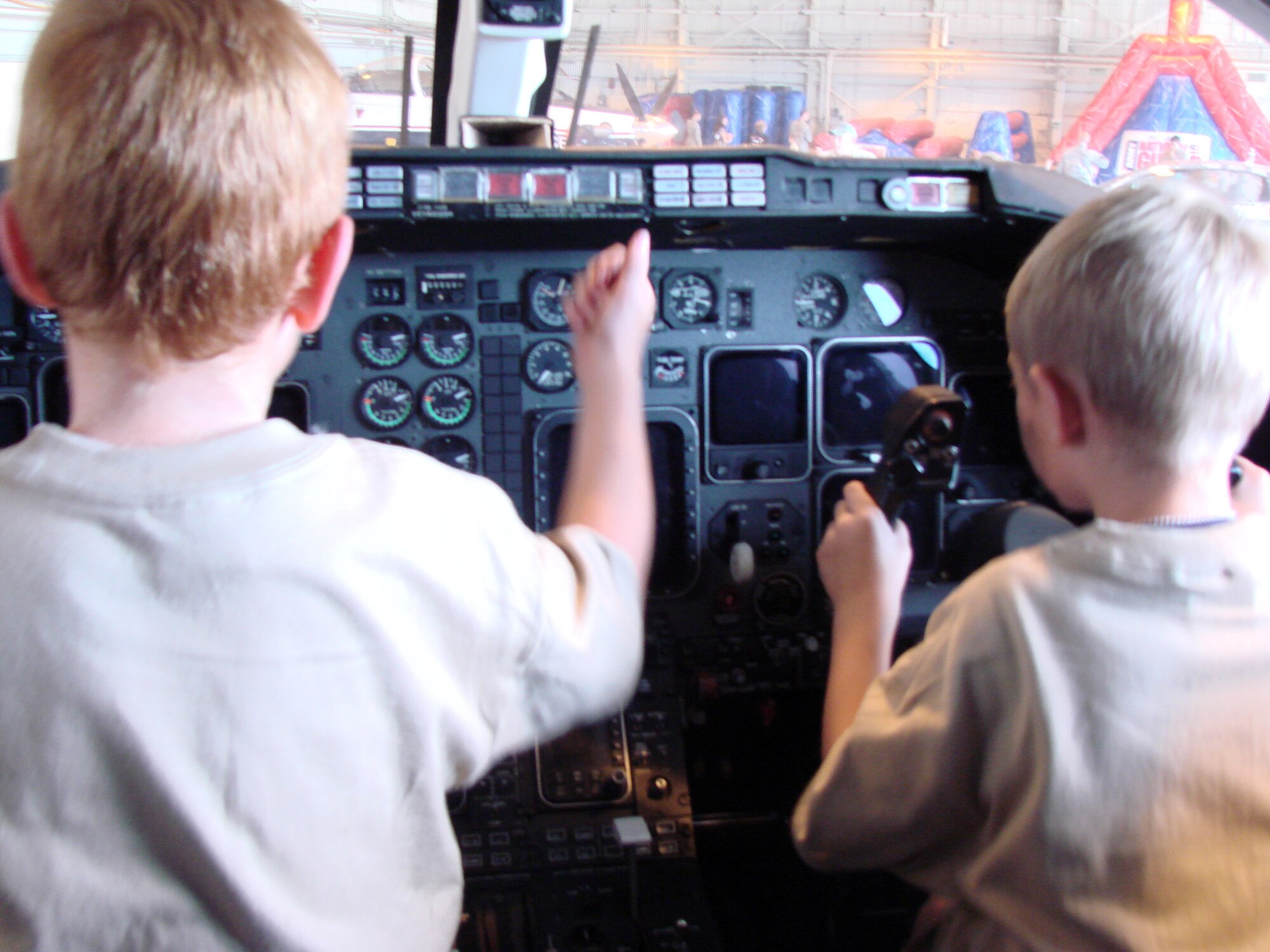 From left, Christian Browne and Russell Starcher sit in the cockpit of a T-1 Jayhawk and pretend to fly at Camp Liberty in Hangar 170, the “deployment” site for the Operation KIDS event, Aug. 6 at Vance AFB, Okla. The event was a hands-on activity for children of military families to learn about their parents’ deployment process. (U.S. Air Force photo/ Danielle Lutes)