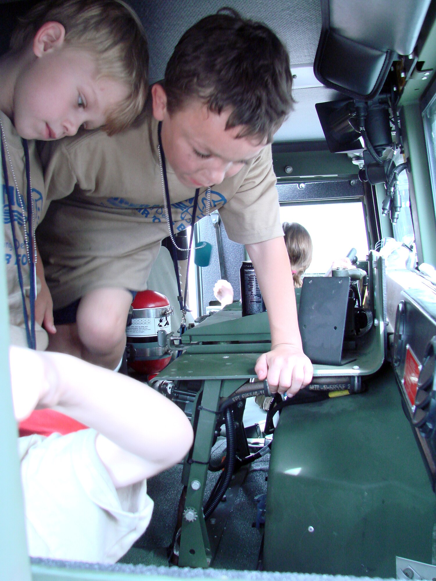 A group of children explores the inside of a jeep at Camp Liberty in Hangar 170, the “deployment” site for the Operation KIDS event, Aug. 6 at Vance AFB, Okla. The event was a hands-on activity for children of military families to learn about their parents’ deployment process. (U.S. Air Force photo/ Danielle Lutes)