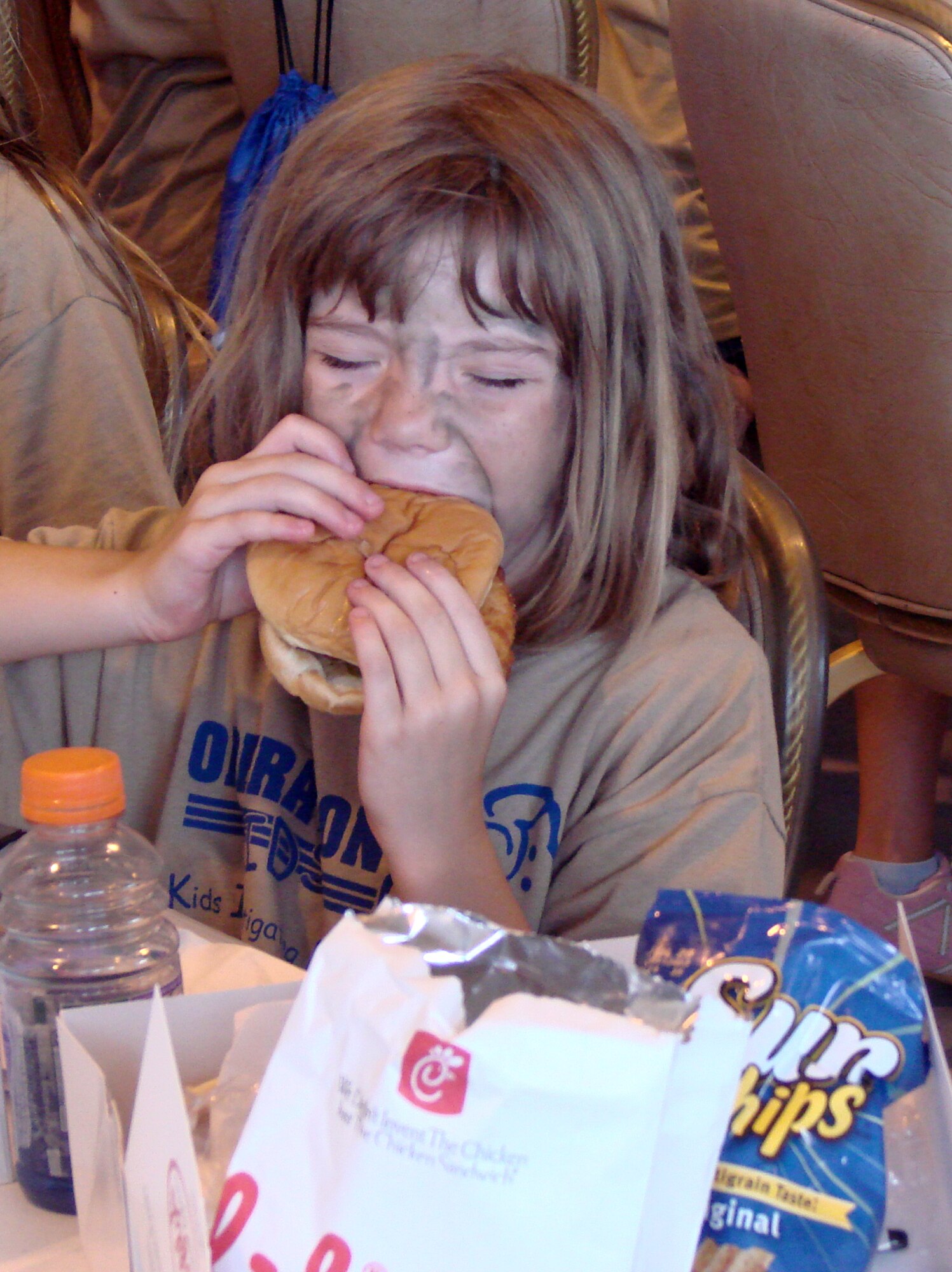 Makaley Waide takes a big bite out of a burger at Camp Liberty in Hangar 170, the “deployment” site for the Operation KIDS event, Aug. 6 at Vance AFB, Okla. The event was a hands-on activity for children of military families to learn about their parents’ deployment process. (U.S. Air Force photo/ Danielle Lutes)
