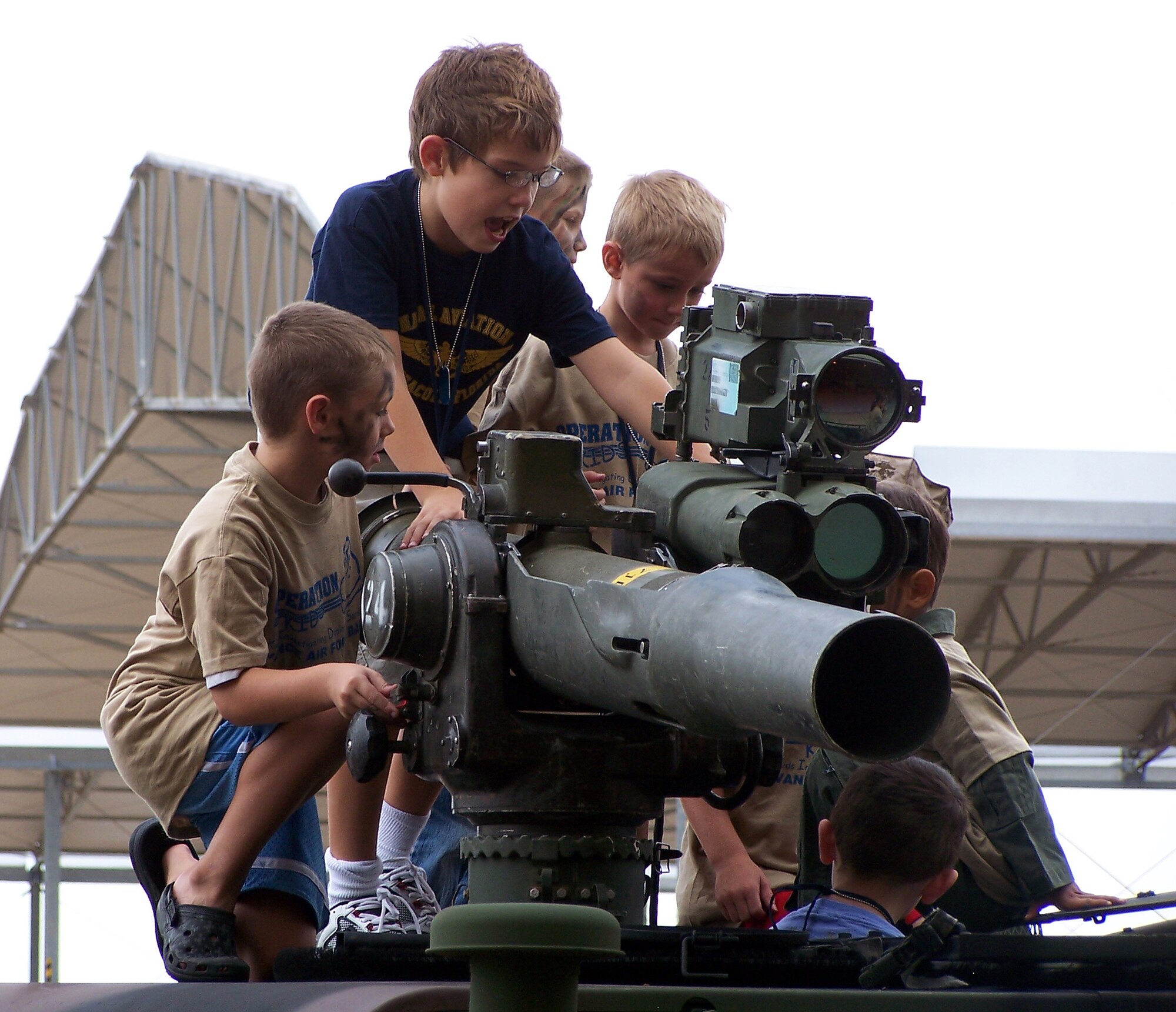 A group of children explores the top of a jeep brought by the U.S. Marines Anti-Tank Training Company from Broken Arrow, Okla., during the Operation KIDS event, Aug. 6 at Vance AFB, Okla. The event was a hands-on activity for children of military families to learn about their parents’ deployment process. (U.S. Air Force photo/ Lisa Hoth)