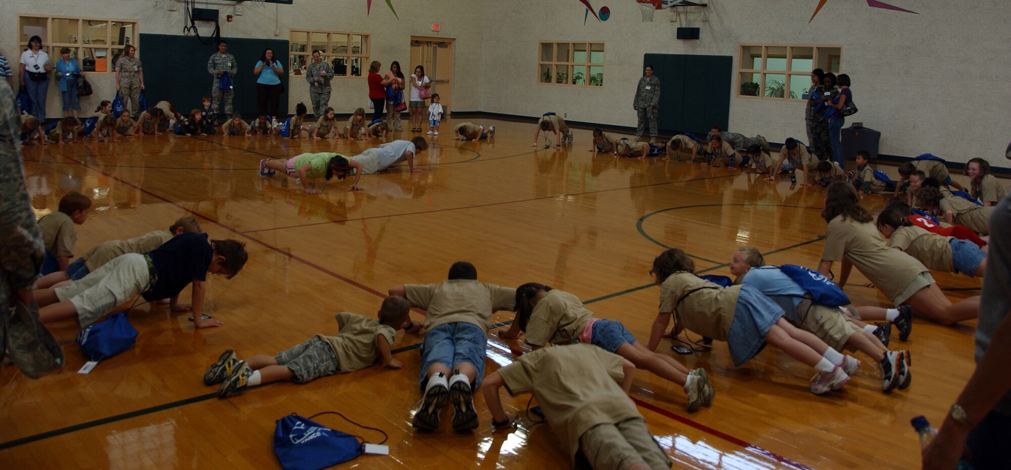 Children participating in Operation KIDS, Aug. 6 at Vance AFB, Okla., do pushups in the Fitness Center as part of their physical training before “deploying” to Camp Liberty in Hangar 170. Operation KIDS was a hands-on event for children of military families to learn about their parents’ deployment process. (U.S. Air Force photo/ 1st Lt. Agneta Murnan)