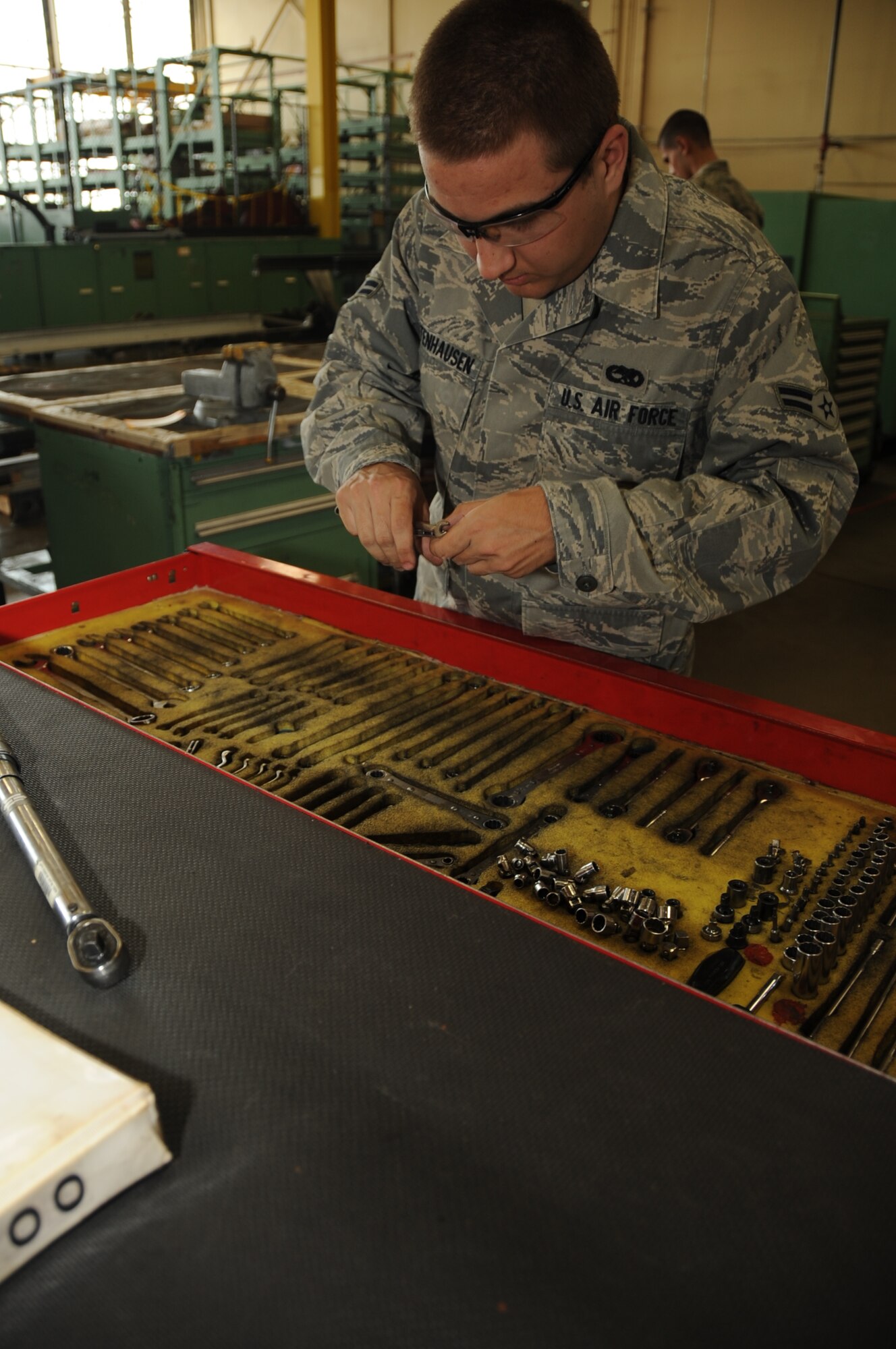 Airman 1st Class Jon Bettenhausen, 28th Maintenance Squadron aerospace propulsion apprentice, selects tools from before working on a B-1B Lancer engine here, August 13.  Airman Bettenhausen along with several others repair faulty pieces, replace broken parts and ensure proper functionality on B-1B engines. (U.S Air Force photo/Airman 1st Class Anthony Sanchelli)