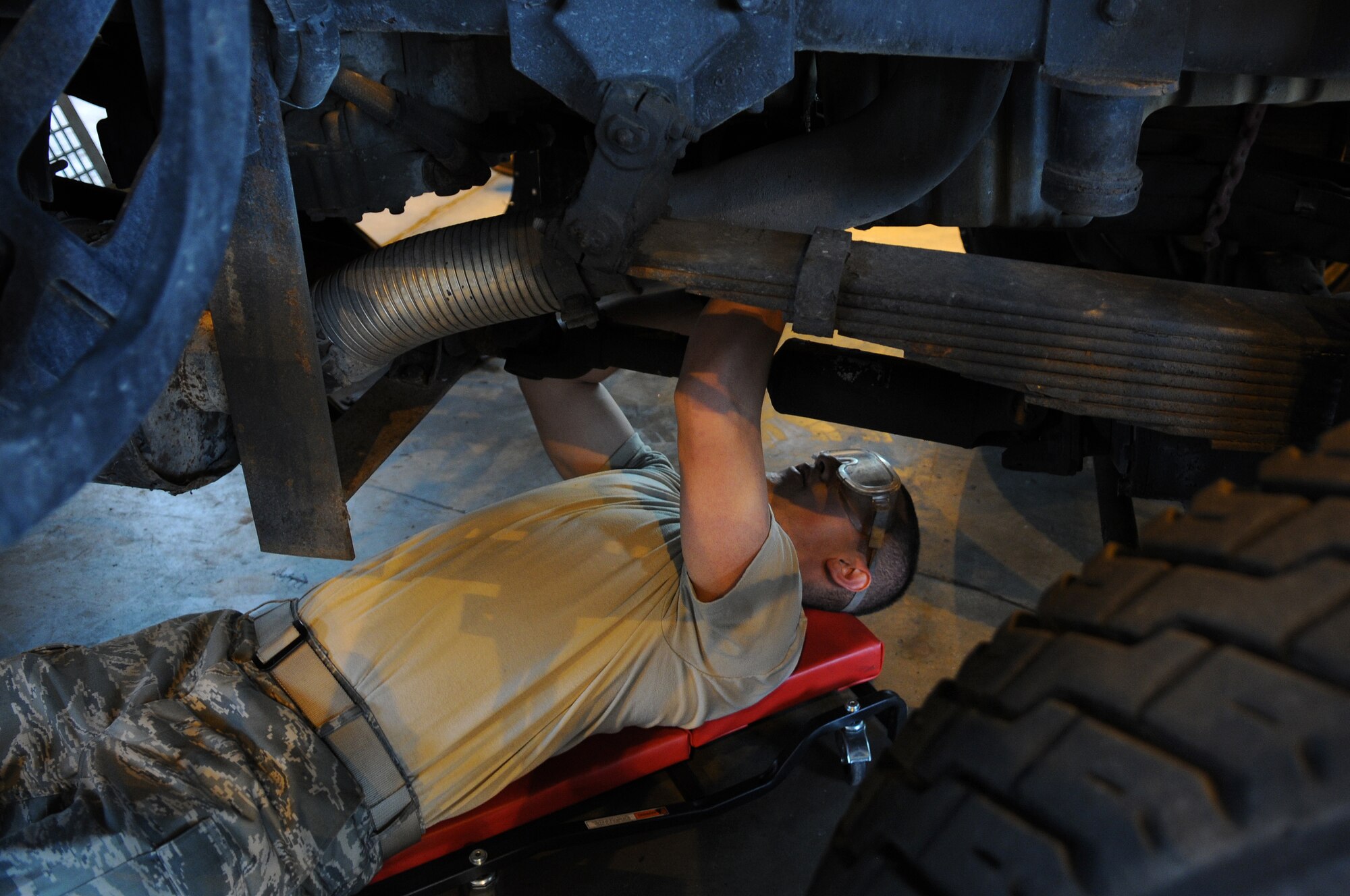 U.S Air Force Airman Carlos Limon, 86th Vehicle Readiness Squadron vehicle and vehicular apprentice, works on a flightline sweeper on Aug. 14, 2009, Ramstein Air Base, Germany. The 86th VRS squadron has the biggest fleet in the Air Force with about 2,100 vehicles to maintain. (U.S. Air Force photo by Airman 1st Class Grovert Fuentes-Contreras)
