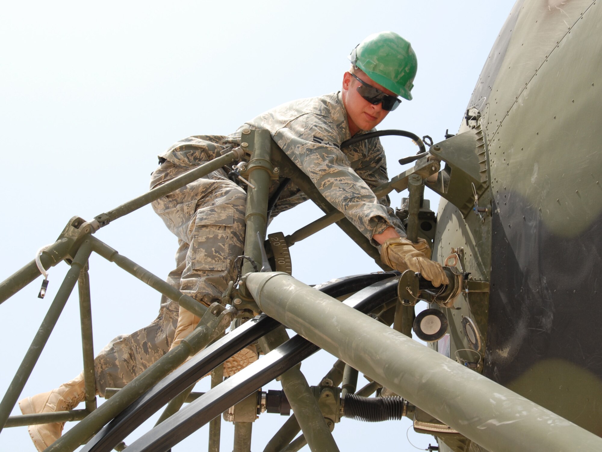 Airman 1st Class Daniel Wheaton, 379th Expeditionary Communications Squadron satellite wideband and telemetry journeyman, adjusts the wave guide for the AN/TRC-170 satellite dish, here, Aug. 18, 2009. Airman Wheaton is a native of Chattanooga, Tenn., and is deployed from Tinker Air Force Base, Okla. in support of Operations Iraqi and Enduring Freedom.  (U.S. Air Force Photo/Tech. Sgt. Jason W. Edwards)
