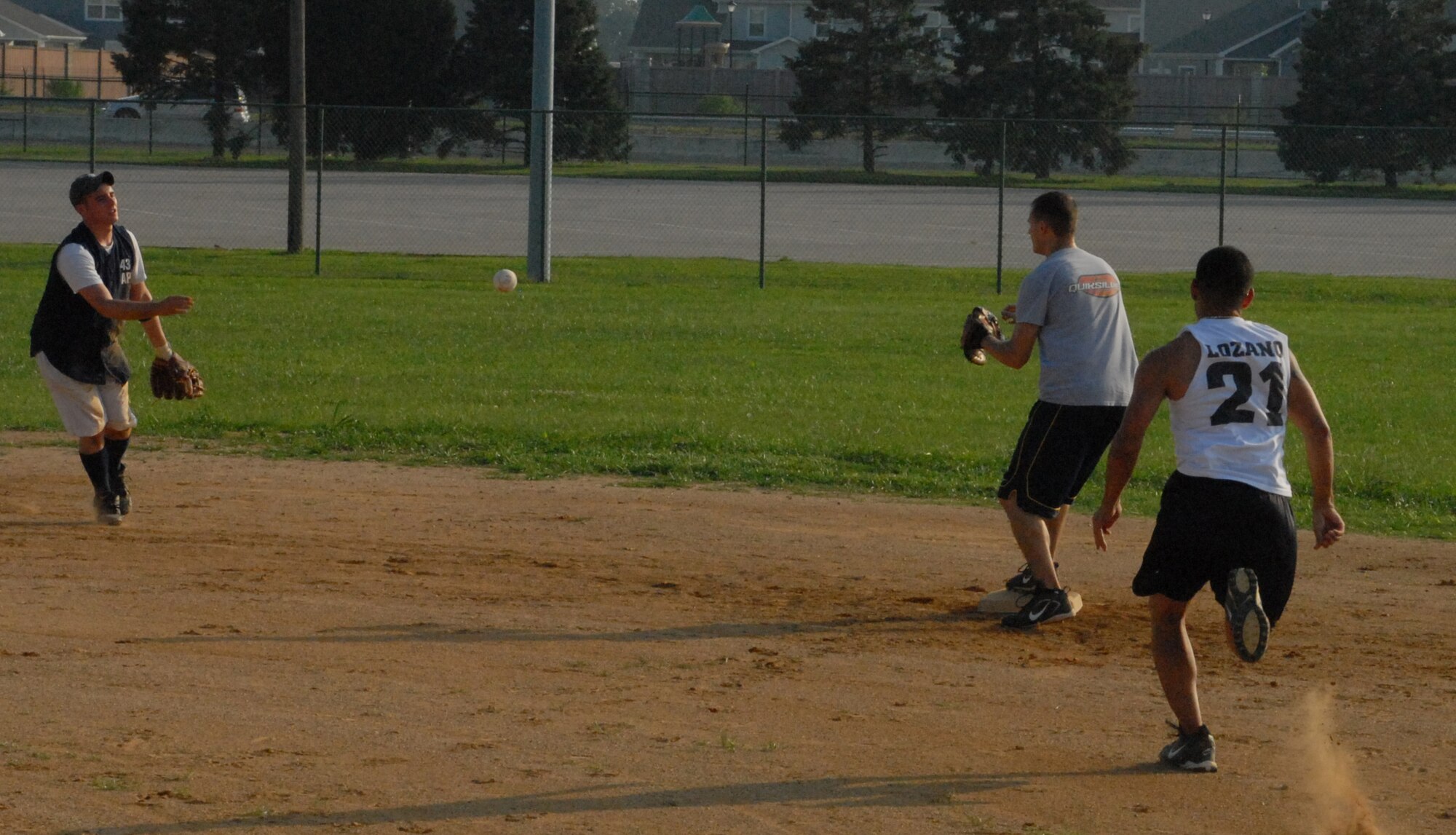 Joshua Yoder, 436th Aerial Port Squadron short stop, throws to Christopher Horning, 436th APS second baseman,j as Angel Lozano, 436th Medical Group, tries to make it to second.