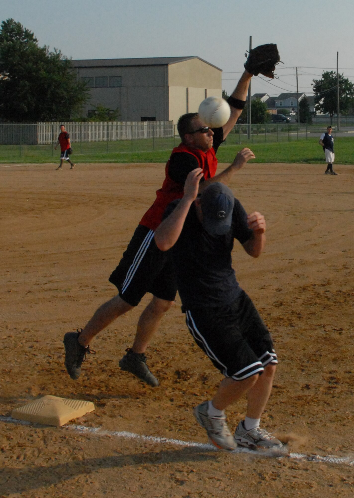 Darin Smith, 436th Aerial Port Squadron first baseman, misses an overthrown ball, as William Downs, 436th Medical Group, is called safe at first.