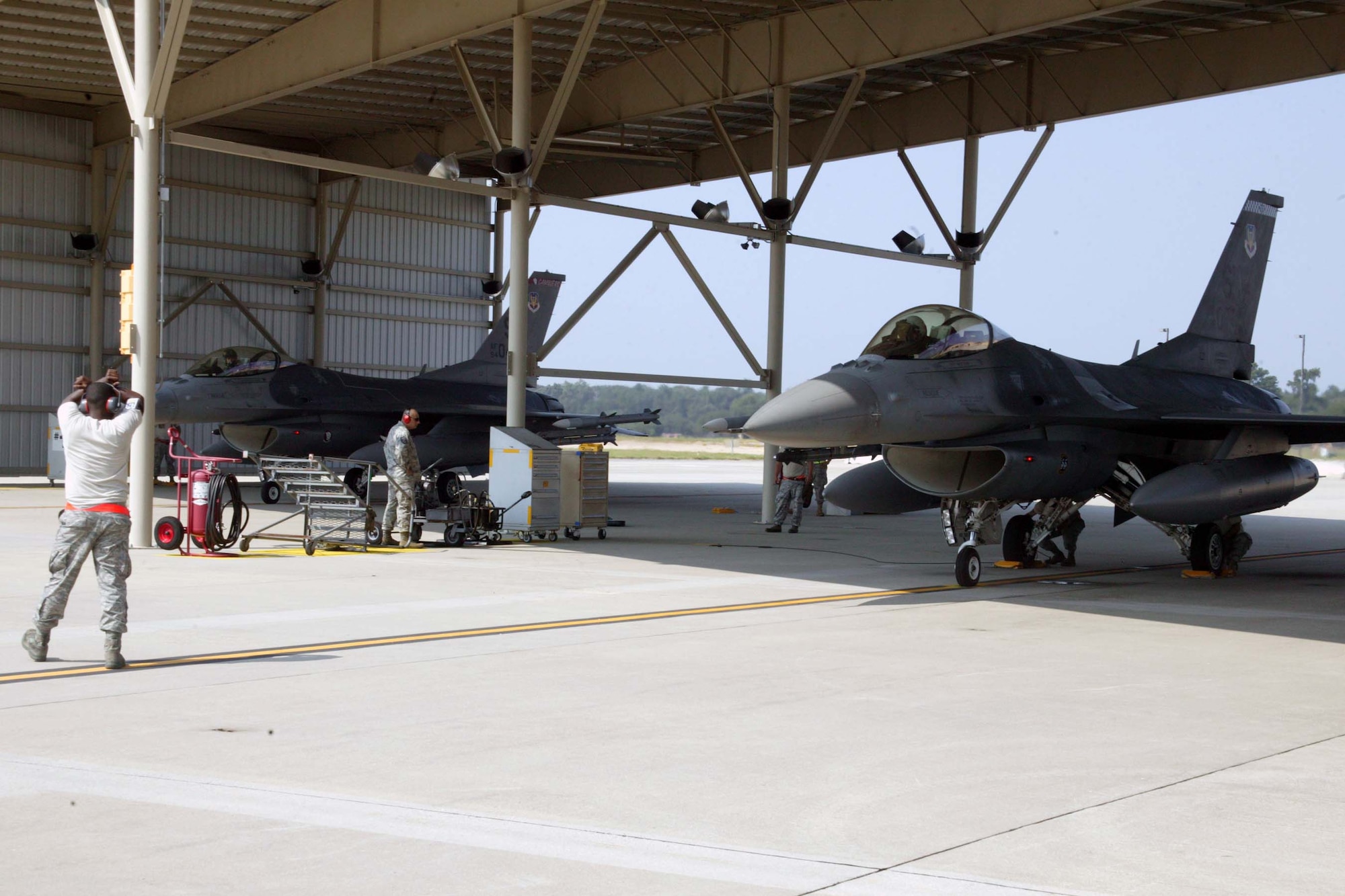 SHAW AIR FORCE BASE, S.C. -- Engines running, alert F-16s ready to roll during an alert-mission exercise here Aug. 11. The exercise, using Civil Air Patrol aircraft as targets, provides training for the alert maintenance crew and pilots for real-world situations. (U.S. Air Force photo/Staff Sgt. John Gordinier)