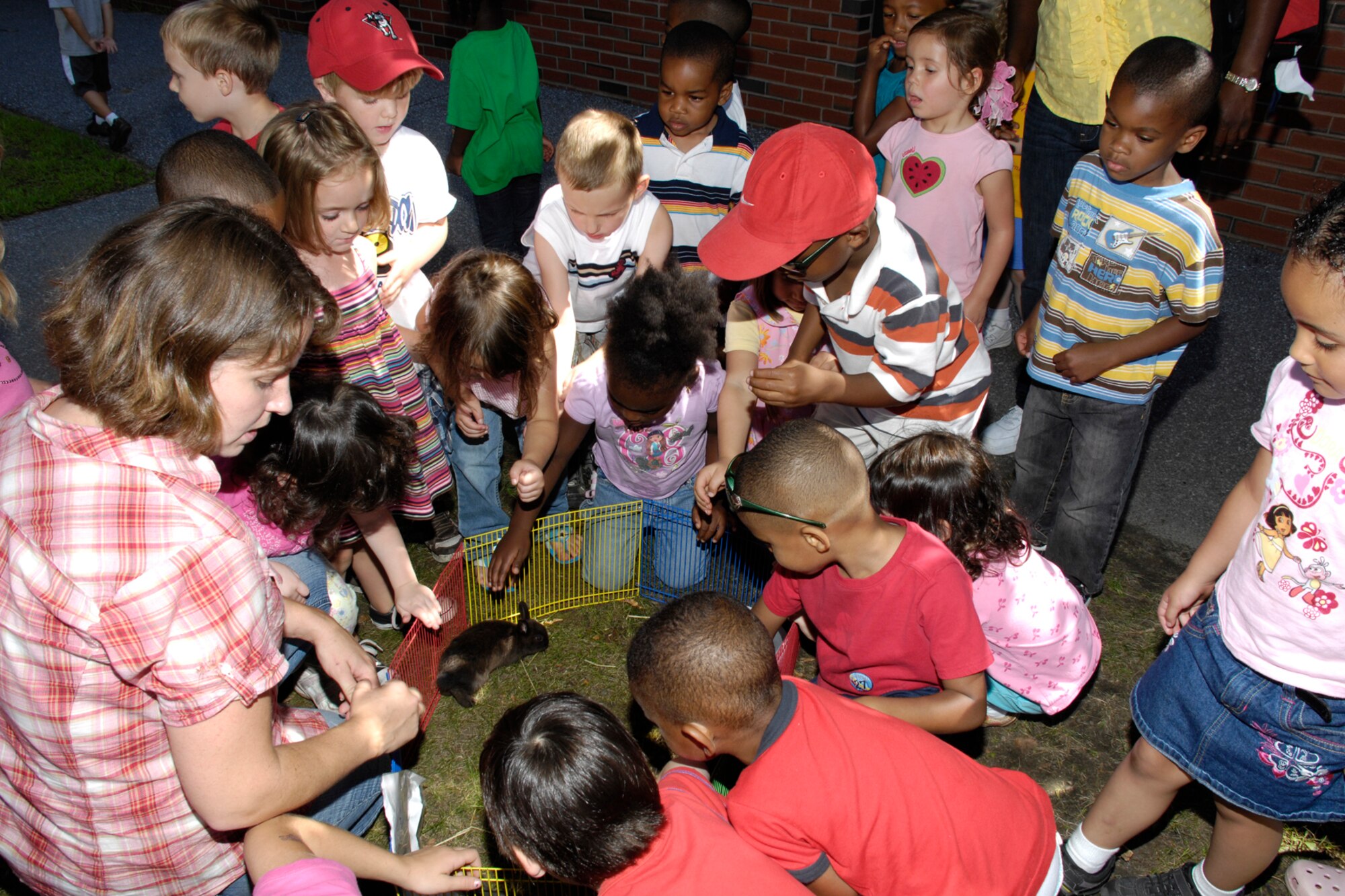 HANSCOM AIR FORCE BASE, Mass. – Children at the Hanscom Child Development Center learn about Baby Netherland Dwarf bunnies during a petting zoo visit to the Center on Aug. 14.  Children had the opportunity to feed, hold and learn about a variety of animals during the visit. (U.S. Air Force photo by Linda LaBonte Britt)