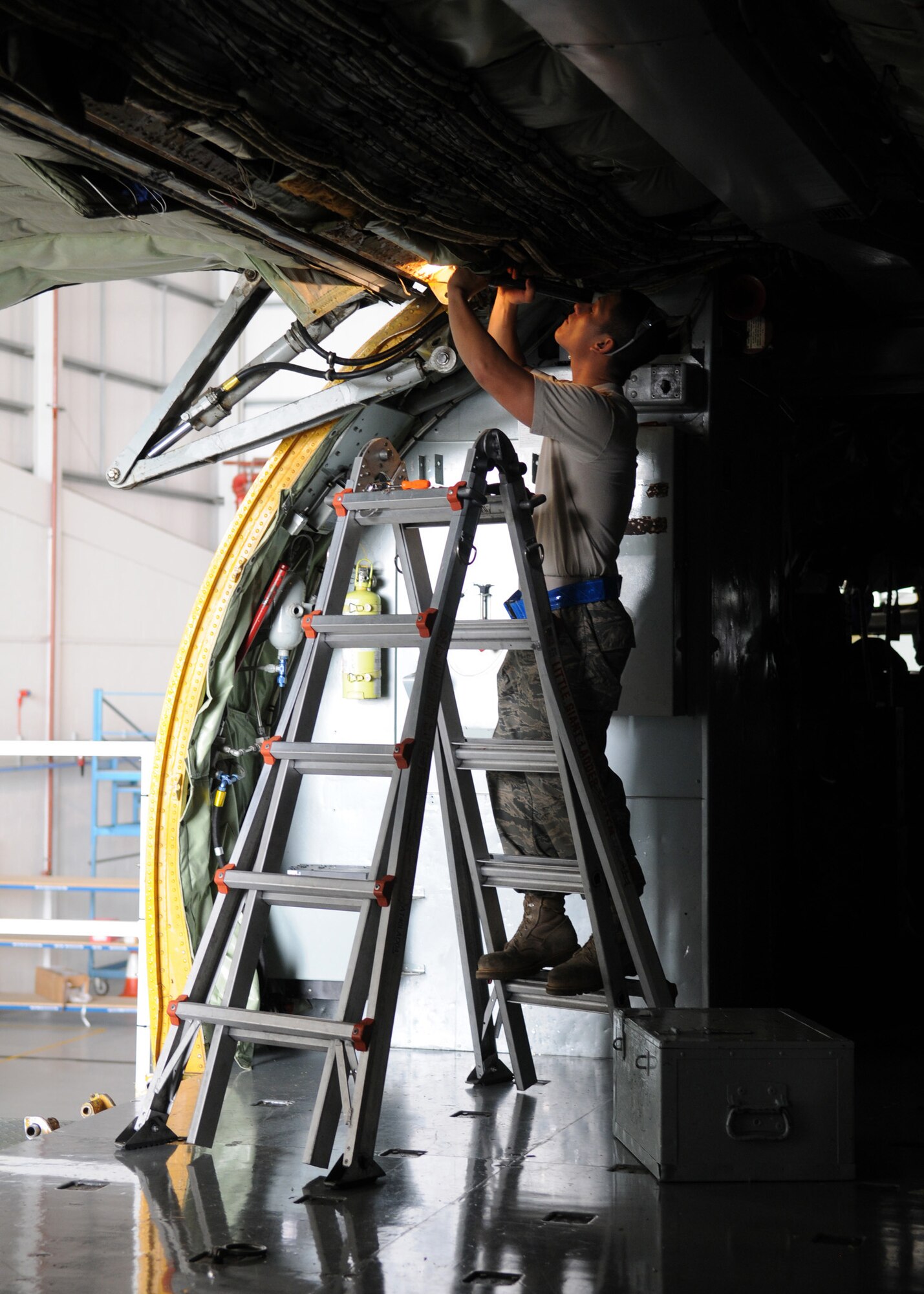 RAF MILDENHALL, England – Senior Airman Mark Redieck, 100th Maintenance Squadron crew chief journeyman, replaces a broken bonding wire in the cargo door during an isochronal inspection Aug 13, 2009. The purpose of the inspection is to ensure reliable, safe and mission ready aircraft. (U.S. Air Force photo by Staff Sgt. Jerry Fleshman)