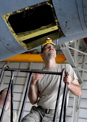 RAF MILDENHALL, England – Tech. Sgt. Christopher Comeau, 100th Maintenance Squadron crew chief craftsman, completes a door installation on a KC-135 during an isochronal inspection Aug. 12, 2009. The purpose of the inspection is to ensure reliable, safe and mission ready aircraft. (U.S. Air Force photo by Staff Sgt. Jerry Fleshman)