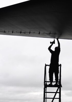 RAF MILDENHALL, England – Senior Airman Curtis Huff, 100th Maintenance Squadron crew chief journeyman, installs a panel to the underside of the rear horizontal stabilizer during an isochronal inspection Aug. 12, 2009. The purpose of the inspection is to ensure reliable, safe and mission ready aircraft. (U.S. Air Force photo by Staff Sgt. Jerry Fleshman)