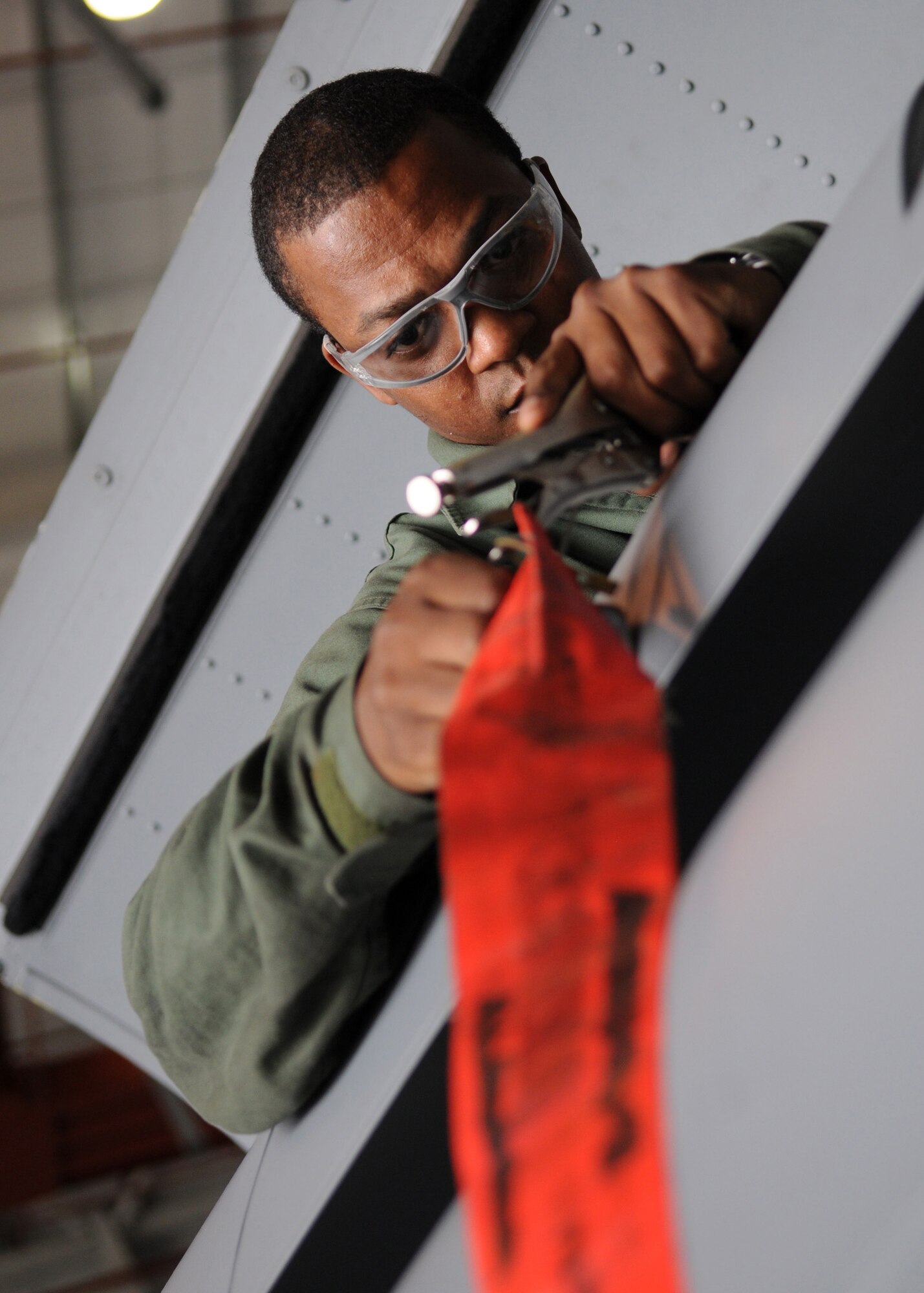RAF MILDENHALL, England - Staff Sgt. Richard Butler, 100th Maintenance Squadron communications and navigation craftsman, connects a flap transmitter cable to a flap on a KC-135 during the isochronal inspection inside Hanger 814 Aug. 12, 2009. Sergeant Butler and his team perform numerous detailed inspections on the entire aircraft to ensure safety and mission readiness. (U.S. Air Force photo by Staff Sgt. Jerry Fleshman)