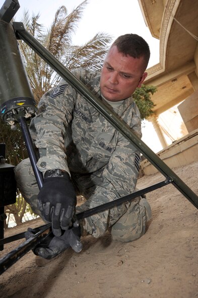 CAMP VICTORY, Iraq ? Air Force Tech. Sgt. Terry Hutton, weather system support cadre team lead, sets-up a tactical meteorological weather equipment here July 30, 2009. Sergeant Hutton is responsible for maintaining and repairing 30 of these systems throughout Iraq. The equipment, also known as TMQ-53, is used to obtain pressure, wind speed and direction, temperature, dew point, relative humidity, precipitation, surface visibility, cloud height and lightning detection. Sergeant Hutton is deployed from Hurlburt Field Air Force Base, Fla., and is a native of Enid, Okla.  (U.S. Air Force photo/Tech. Sgt. Johnny L. Saldivar/Released) 
