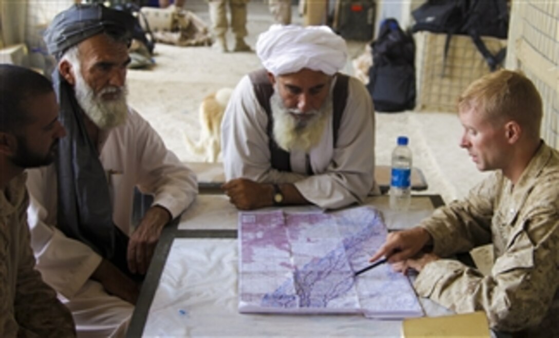 U.S. Marine Corps Lt. Col. William McCollough, commander of the 1st Battalion, 5th Marine Regiment, talks to the district administrator (2nd from left) and a town elder (2nd from right) in the Nawa district of Afghanistan's Helmand province on Aug. 16, 2009.  The 1st Battalion, 5th Marine Regiment is deployed with Regimental Combat Team 3 to conduct counter insurgency operations in partnership with Afghan National Security Forces in southern Afghanistan.  